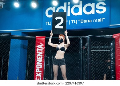 Minsk, Belarus, April 25, 2020. New Fighting Generation, Mixed Martial Arts. Mma, Girl Model In A Black Leather Suit  And Medical Mask In The Ring, In The Octagon, Announcement Of The Round