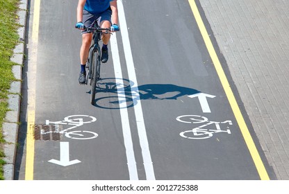 Minsk, Belarus. Aug 2019. Caucasian Man Ride Bicycle. Bike Path And Cyclist On Bicycle, View From Above. Bike Lane For Cyclist. Bicycle Road Sign Painted On Pavement. Bicycle Lane And Sign On Road