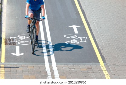 Minsk, Belarus. Aug 2019. Caucasian Man Ride Bicycle. Bike Path And Cyclist On Bicycle, View From Above. Bike Lane For Cyclist. Bicycle Road Sign Painted On Pavement. Bicycle Lane And Sign On Road