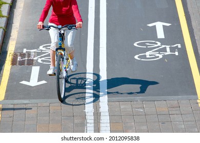 Minsk, Belarus. Aug 2019. Woman Ride Bicycle. Bike Path And Cyclist On Bicycle In City, View From Above. Bike Lane For Cyclist. Bicycle Road Sign Painted On Pavement. Bicycle Lane And Sign On Road