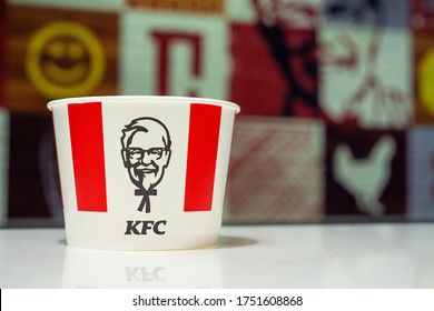 Minsk, Belarus - august 10, 2019: Bucket with KFC logo on table in KFC Restaurant