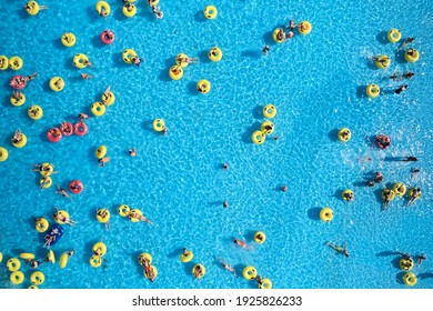 Minsk, Belarus - August 19, 2019. Waterpark. Top View - Young People Relax In Swimming Pool At Bubble Bath. Water Park Background.