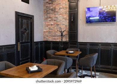 Minsk, Belarus - Dec 20, 2021: Cafe Interior With Cozy Tables And TV On The Wall