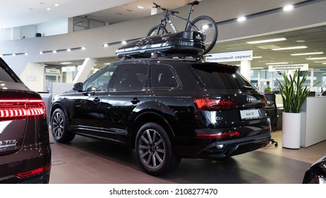 Minsk, Belarus - Dec 20, 2021: A New Black Audi Q7 Premium SUV With A Bike And A Roof Rack In The Showroom Of An Audi Dealership