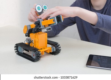 Minsk, Belarus. February, 2018. Teenager Child Schoolboy Programmes Ubtech Jimu Robot On Ipad Apple. Robot For STEM Education At The Classroom. Code The Bot. Robotics. Progressive American Education. 