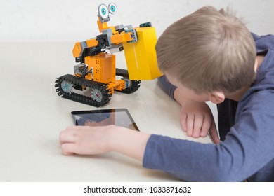 Minsk, Belarus. February, 2018. Teenager Child Schoolboy Programmes Ubtech Jimu Robot On Ipad Apple. Robot For STEM Education At The Classroom. Code The Bot. Robotics. Progressive American Education. 