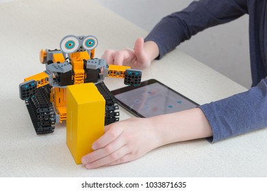 Minsk, Belarus. February, 2018. Teenager Child Schoolboy Programmes Ubtech Jimu Robot On Ipad Apple. Robot For STEM Education At The Classroom. Code The Bot. Robotics. Progressive American Education. 