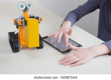 Minsk, Belarus. February, 2018. Teenager Child Schoolboy Programmes Ubtech Jimu Robot On Ipad Apple. Robot For STEM Education At The Classroom. Code The Bot. Robotics. Progressive American Education. 