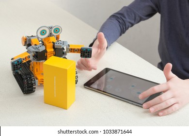 Minsk, Belarus. February, 2018. Teenager Child Schoolboy Programmes Ubtech Jimu Robot On Ipad Apple. Robot For STEM Education At The Classroom. Code The Bot. Robotics. Progressive American Education. 