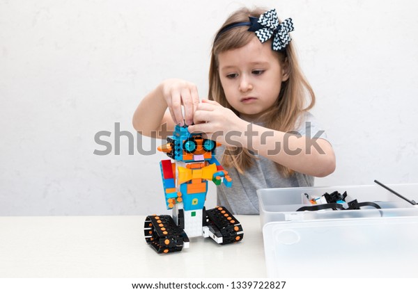 Minsk,\
Belarus. February, 2019. STEM and STEAM education. Cute little girl\
code robot in the class of engineering and chemistry on Scratch.\
Lego Boost. Modern technologies.\
Robotics.