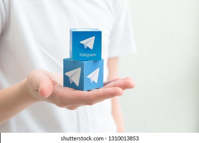 Minsk, Belarus. February, 2019. Teenager Boy Holds Social Network Telegram Logo In His Hand. White Background.