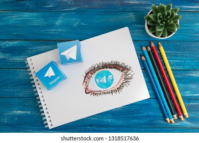 Minsk, Belarus. February, 2019. A Teenager Boy Draws The Eye Of A Man. There Is The Logo Of A Well-known Social Network Telegram Messenger In The Eye.