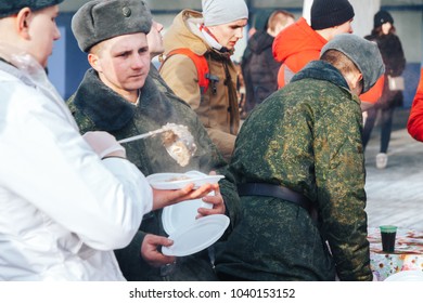 Minsk, Belarus. February 23, 2018 Promotion of a healthy lifestyle 'Running real men' A soldier in a white robe imposes mush