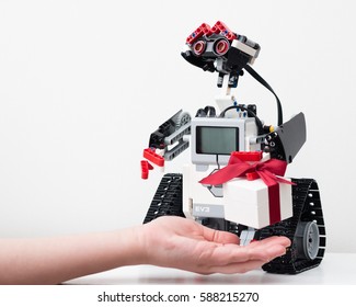 Minsk, Belarus -  February 26, 2017: Lego Robot Has Prepared A Gift - The Pandora Jewelery Box And Beautiful Orchid Flower. Girl's Hand. Gold And Silver Jewelry. School. E-learning.  STEM Education.