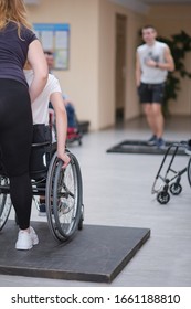 Minsk, Belarus, February 29,2020 rehabilitation instructor teaches disabled girl active wheelchair techniques , Rehab Center - Shutterstock ID 1661188810