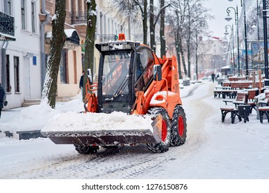 Minsk, Belarus - Jan 2019. Skid Steer Loader On Komsomolskaya Street Remove Snow. Snow Removal Work By Municipal Services, Sidewalk Cleaning From Ice And Snow After Heavy Snowfall