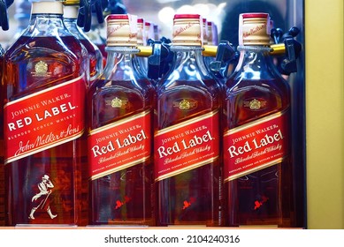 Minsk, Belarus. Jan 2022. Johnnie Walker Red Label - Bottles Of Popular Blended Scotch Whisky On Supermarket Shelf. Johnnie Walker Red Label Blended Whisky Bottles On Display.