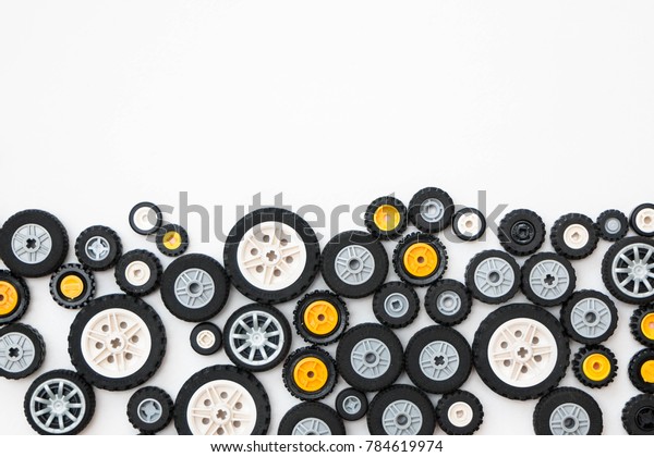Minsk, Belarus - January, 2018. Composition of the\
wheels from the toy cars Lego. Background. For child to build and\
construct, play.