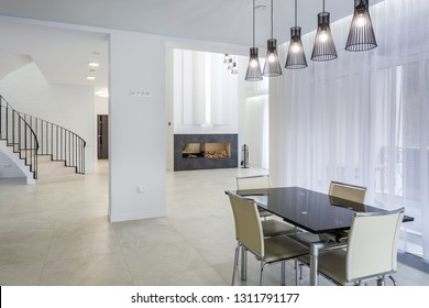 MINSK, BELARUS - JANUARY, 2019: Interior of the modern kitchen  and guest hall in loft flat in minimalistic style with black color