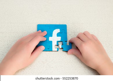 Minsk, Belarus - January 8, 2017: Facebook Logo. Teen Drawing On The Puzzles. Handmade. Child Puts Puzzles. Fashion And Famouse Social Network Around The World. 