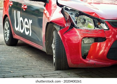 Minsk, Belarus - Jul 2021. Uber Taxi Car Crashed. Damaged Front Body Parts, Broken Headlight, Fender And Bumper Of Uber Taxi Car. Taxi Wrecked In Traffic Accident, Unsafe Driving, Traffic Violation.