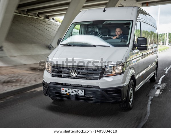 MINSK, BELARUS - July 20, 2019: Big white\
2nd generation Volkswagen Crafter 2019 drives on a highway. Crafter\
offers a range of wheelbases and body sizes. It is powered by a\
2.0-litre turbo-diesel.