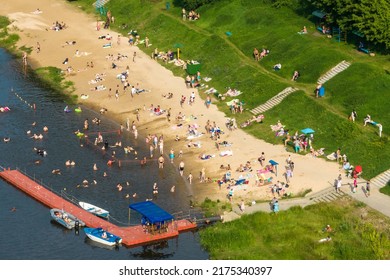 MINSk, BELARUS - JULY 2022: Aerial View On Large Crowd Of People On The City Beach Near The River With A Lifesaving Station And Boats, A Lot Of People Relax Sunbathing On Shore Beach