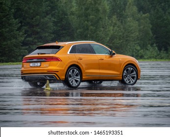 MINSK, BELARUS - JULY 28, 2019: Audi Q8 55 TFSI Quattro 2019 model year drives on a wet asphalt road during test drive event. The car equipped with 3-litre V6 turbo producing 340 hp.