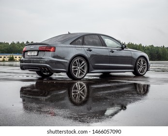 MINSK, BELARUS - JULY 28, 2019: Audi S6 V8T Quattro 2016 model year drives on a wet asphalt road during test drive event. The car equipped with 4-litre V8 turbo producing 450 hp.
