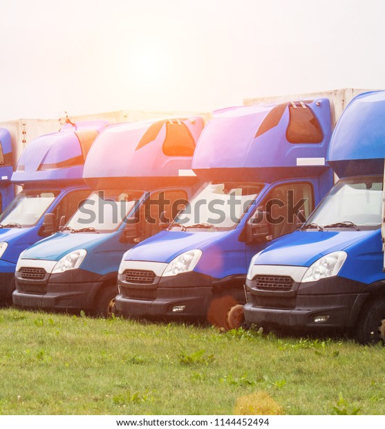 MINSK, BELARUS -\
JULY 3, 2018: Blue cargo vans stand in a row, trucking and\
logistics, trucking industry and\
sun