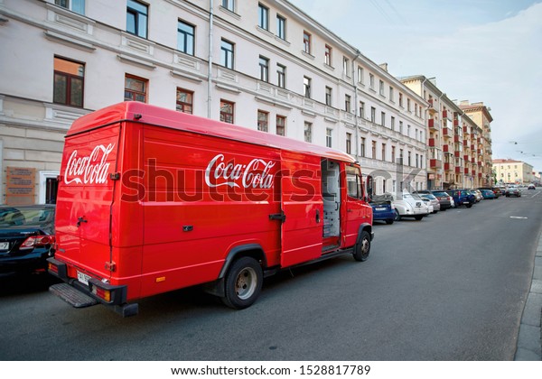 Minsk, Belarus - Jun 2019. Coca Cola branded van\
unloads drinks in the center of old city. Coca-Cola drinks delivery\
from distributor to restaurants. Mercedes-Benz Vario, red Coca-Cola\
truck on street