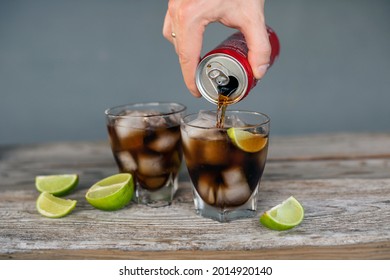 MINSK, BELARUS - JUNE, 2021: Close Up Of A Man's Hand Pouring Coca-cola Into A Cool Cocktail On A Summer Evening.