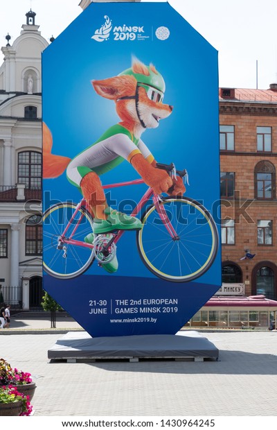 Minsk, Belarus - June 21, 2019.\
Official poster with mascot of 2nd European Games. Ginger Fox Lesik\
riding on bicycle - symbol of second European\
Games.