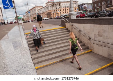 Minsk / Belarus - June 5, 2019: Young Woman And Older Woman In Black Skirts On Subway Station Stairs