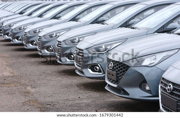 Minsk,\
Belarus. Mar 2020. Hyundai cars parked in row the parking lot of an\
authorized dealer. New cars on holding yard. Hyundai Accent\
vehicles on the parking in row. New cars for\
sale