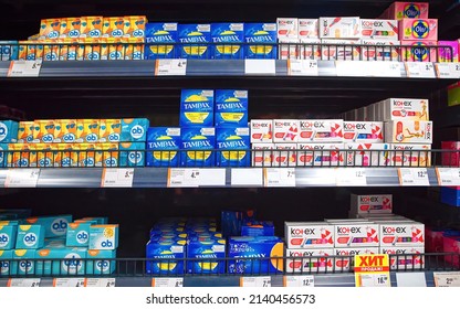 Minsk, Belarus. Mar 2022. Women`s hygiene products, assortment of Tampax, O.B., Kotex on shelf in supermarket. Feminine hygiene products, sanitary protection for women, sanitary napkins and tampons 