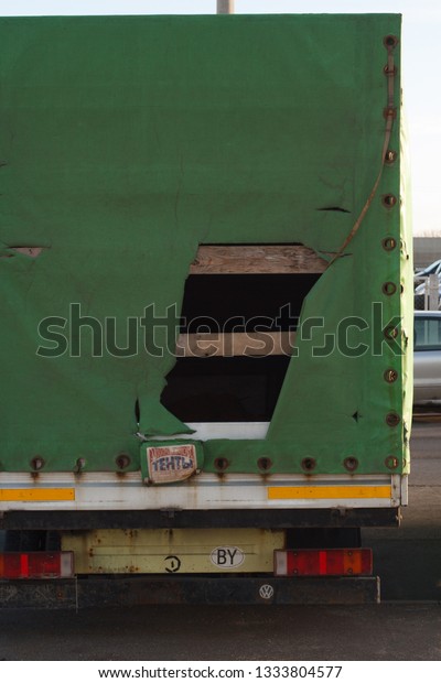 Minsk, Belarus -\
March 09, 2019: Abandoned car on the city street - broken truck car\
parked along the street with torn awning  good for insurance\
related payments\
concept\
