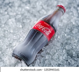MINSK , BELARUS - MARCH 30 2019: Frozen Coca Cola Bottle In Ice. Coca Cola Is The Most Popular Carbonated Soft Drink Beverages Sold Around The World