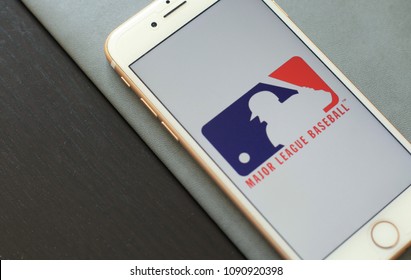 MINSK, BELARUS – May 12, 2018: White Apple IPhone 7. The Official Logo Of The Major League Baseball, MLB Logo.