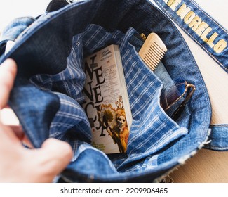 Minsk, Belarus - May 14, 2021: A Woman Collects A Bag For Leaving The House - Car Keys, Hairbrush, Phone And Other Essentials