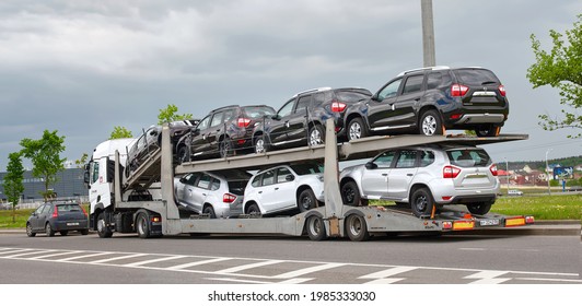Minsk, Belarus. May 2021. Car carrier hauls new cars Nissan Terrano. Car transporter with new Nissan cars parked at roadside. New cars transportation, delivery to dealership.