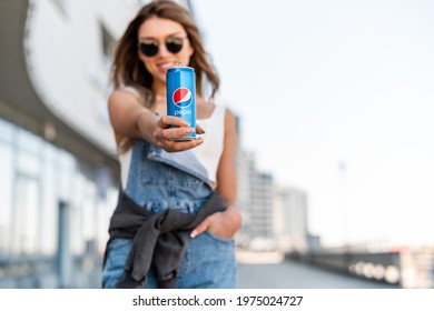 MINSK, BELARUS - MAY, 2021: Happy woman holding can of pepsi