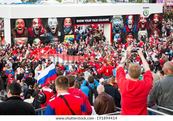 MINSK, BELARUS - MAY 9 - Swiss and Russian Fans with Flags in Front of Minsk Arena on May 9, 2014 in Belarus. Ice Hockey World Championship (IIHF) Opening.