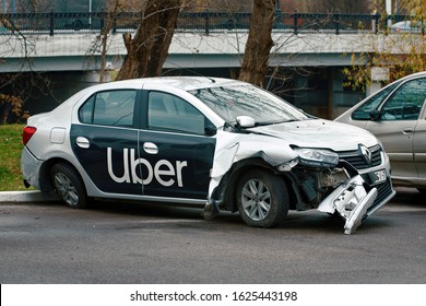 Minsk, Belarus - Nov 2019. Damaged Car Of Uber Taxi Service At The Parked Zone After Car Accident On The Road.  Wrecked Taxi Car After A Head-on Collision In A Parking Lot