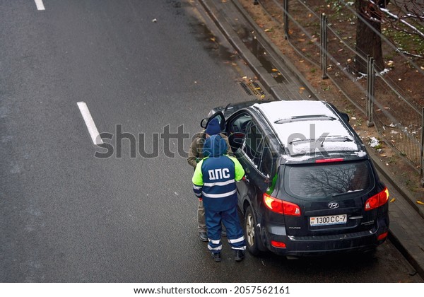 Minsk, Belarus. Nov 2020. Traffic police officer\
stop car at roadside and check drivers license. Prevention traffic\
violation. View from\
above