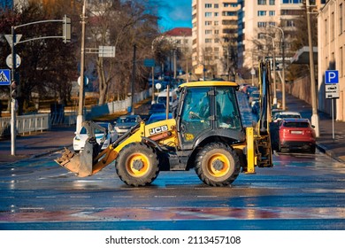 Minsk, Belarus. Nov 2021. JCB 3cx excavator loader drive on city road on construction site. JCB tractor loader on the road, side view.