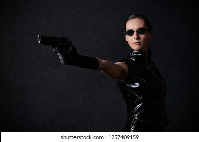 MINSK, BELARUS - NOVEMBER 03, 2018: UniСon Convention & Game Expo Minsk 2018. Cosplayer Young Woman As Trinity From Matrix Shoot On Black Background In Photo Zone