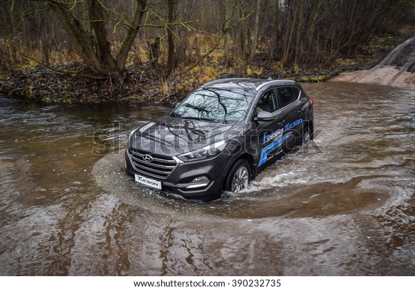 MINSK, BELARUS - NOVEMBER 14, 2015: All-new 2016 model\
year Hyundai Tucson drives along the road during the test-drive\
crossing a river stream. Tucson offers the exciting style and\
versatility. 