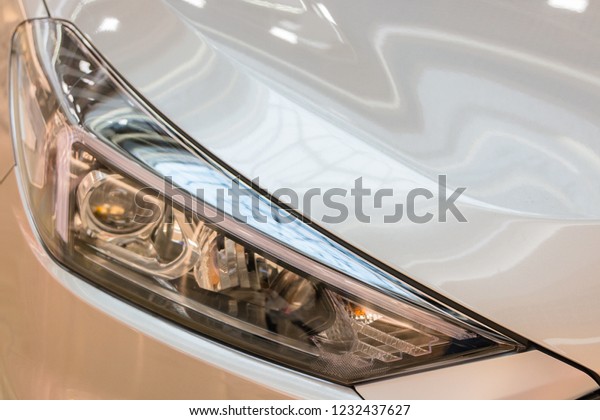 Minsk, Belarus. November,\
2018. The new model of the popular Korean car Hyundai Tucson, IX\
35.Headlight. The palletized car is exposed for sale in a huge\
shopping center.