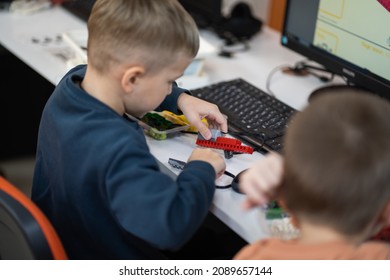 Minsk, Belarus. November, 2021. Little boy constructs and programmes Lego Robot WeDo. Education of children and teenagers. Stem education. Competition. STEAM, DIY.
